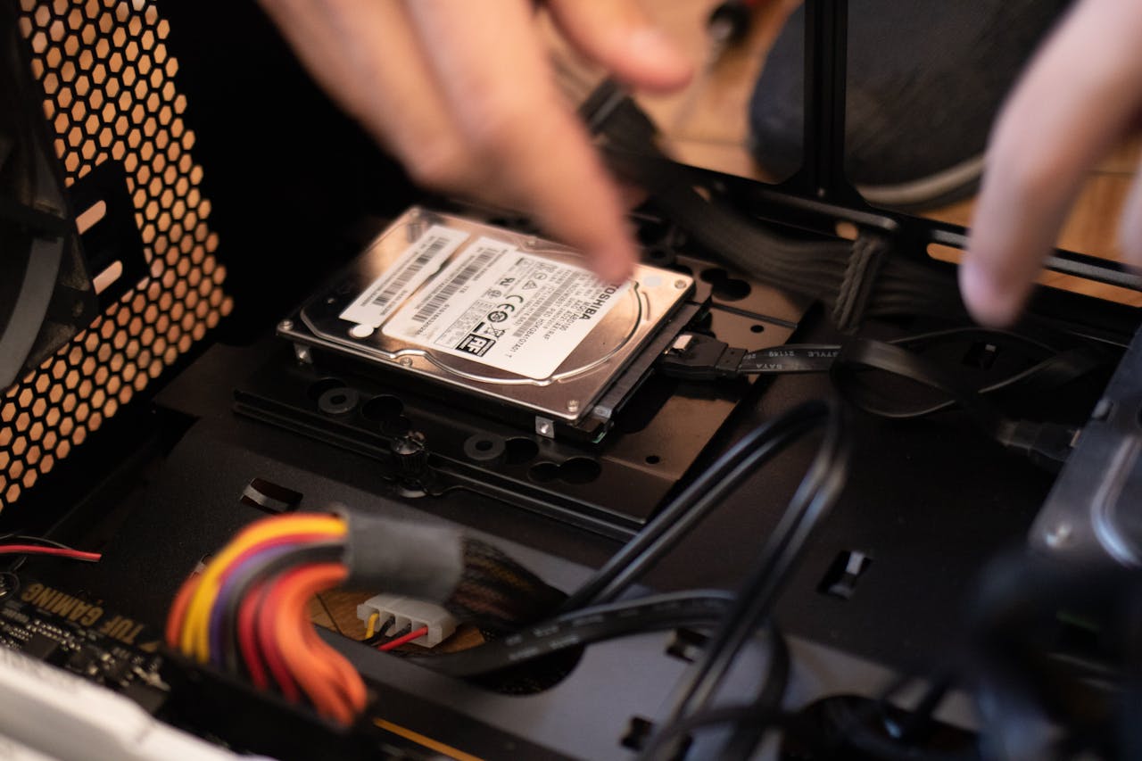 Crafting Captivating Headlines: Your awesome post title goes here Hands installing a hard drive in a computer case, emphasizing technology and connectivity.